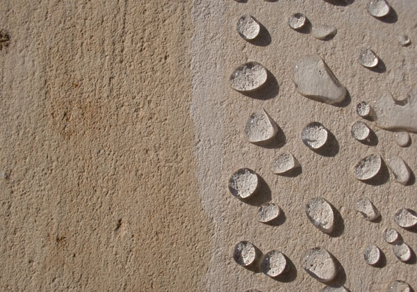 Photographie d'un mur humide traité avec un hydrofuge comparé à un mur non traité